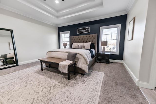 carpeted bedroom featuring ornamental molding, a raised ceiling, and multiple windows