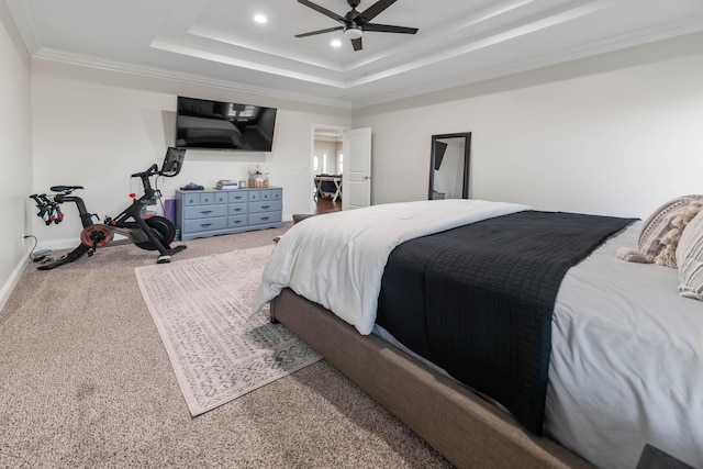 bedroom with crown molding, carpet floors, a raised ceiling, and ceiling fan