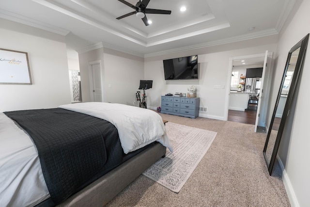 carpeted bedroom with crown molding, ceiling fan, and a raised ceiling