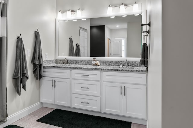 bathroom featuring vanity and hardwood / wood-style floors