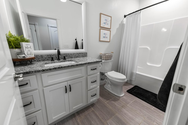 full bathroom featuring vanity, shower / bath combo, and toilet