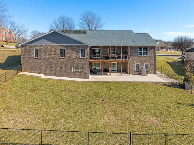 back of house with a lawn, central AC unit, and a patio area