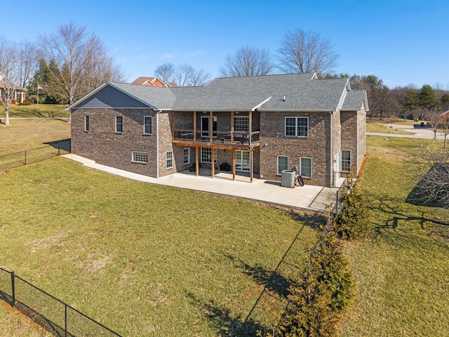 back of house featuring a patio area and a lawn