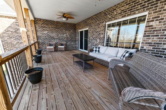 wooden terrace featuring an outdoor hangout area and ceiling fan