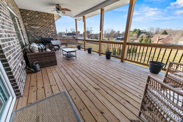 wooden deck with an outdoor living space and ceiling fan