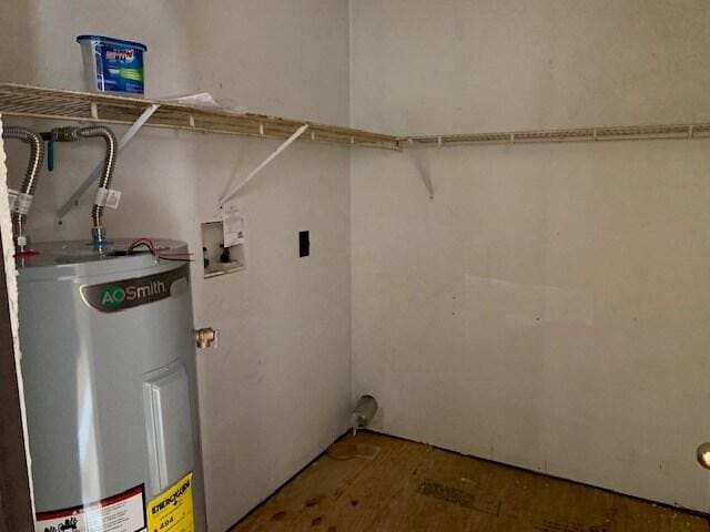 laundry area featuring washer hookup, hardwood / wood-style flooring, water heater, and hookup for an electric dryer