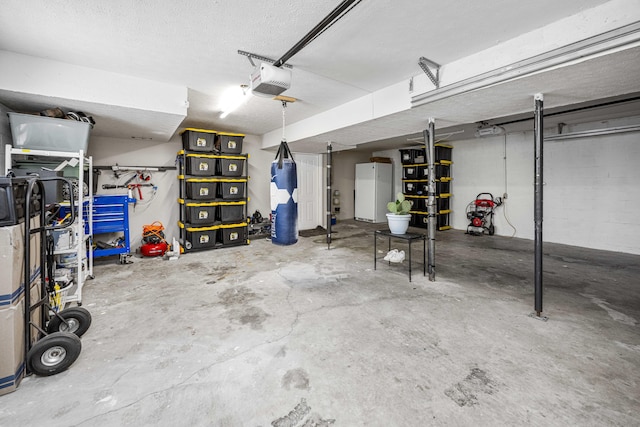 garage with freestanding refrigerator and a garage door opener