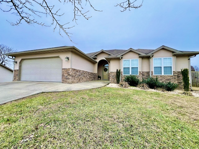 view of front of home with a garage and a front lawn