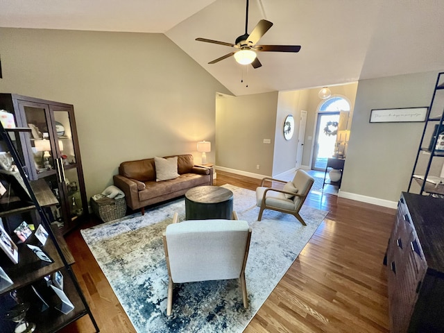 living room with dark hardwood / wood-style flooring, high vaulted ceiling, and ceiling fan