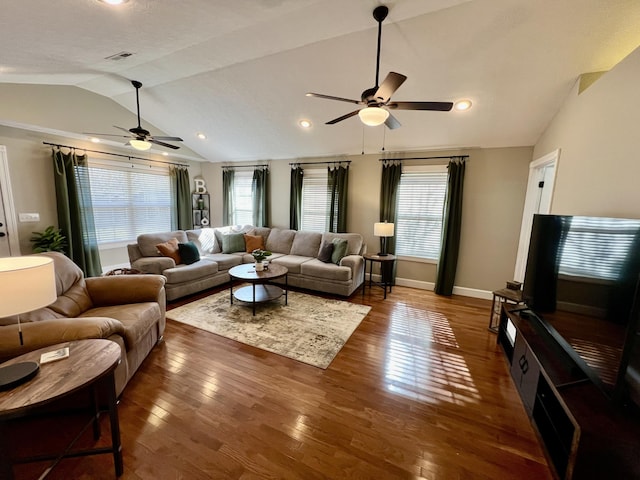 living room with lofted ceiling, dark hardwood / wood-style flooring, a wealth of natural light, and ceiling fan