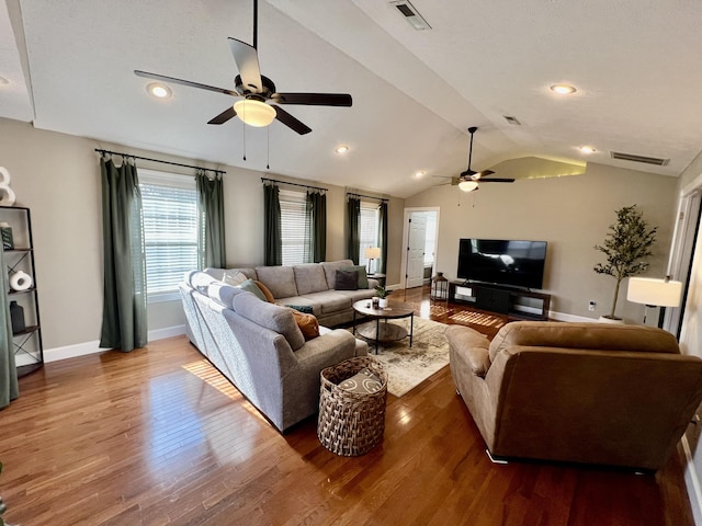 living room featuring ceiling fan, lofted ceiling, and dark hardwood / wood-style flooring