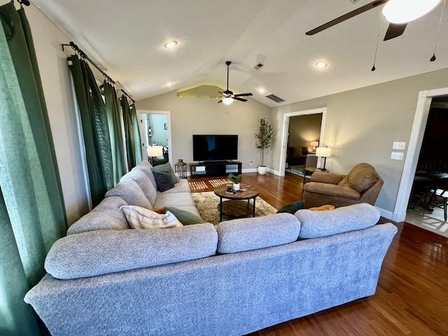 living room featuring dark hardwood / wood-style flooring, vaulted ceiling, and ceiling fan