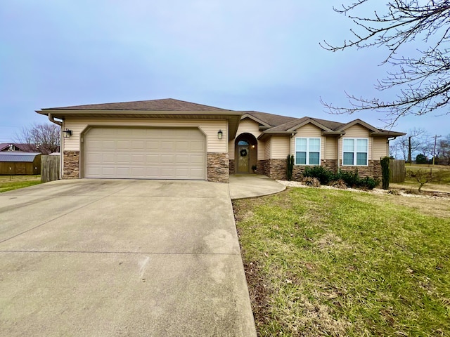 ranch-style house featuring a garage and a front lawn