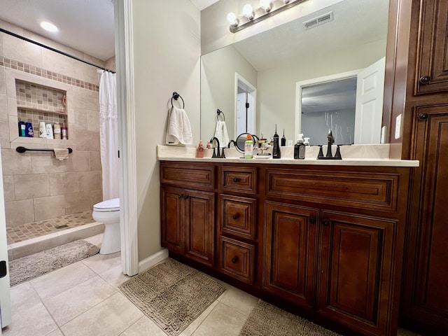 bathroom featuring vanity, tile patterned flooring, curtained shower, and toilet