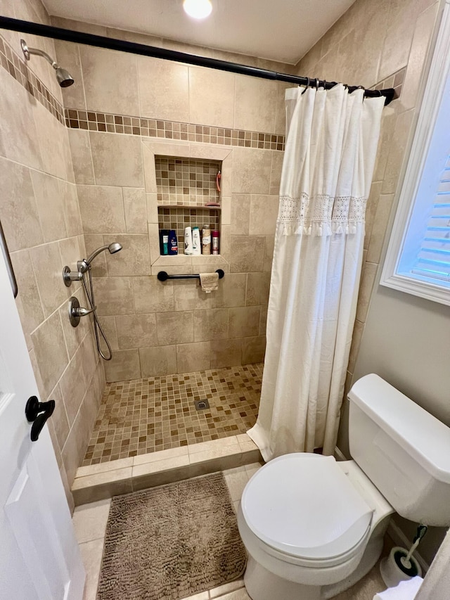 bathroom with curtained shower and toilet