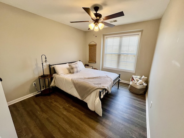 bedroom with dark hardwood / wood-style floors and ceiling fan