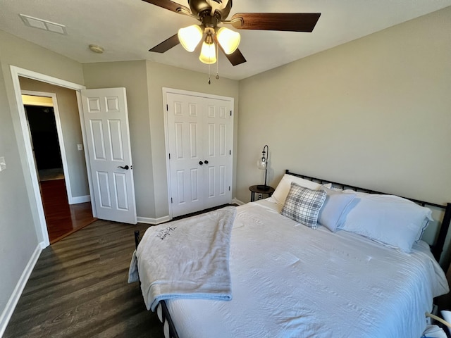 bedroom with dark wood-type flooring, a closet, and ceiling fan