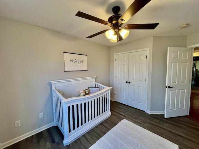 bedroom featuring dark wood-type flooring, a closet, and ceiling fan