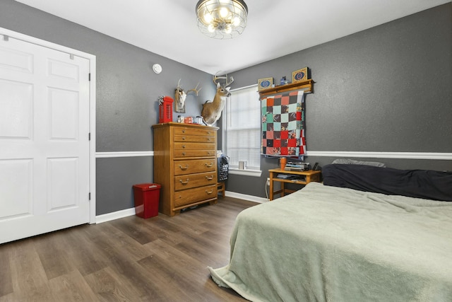 bedroom with dark hardwood / wood-style flooring