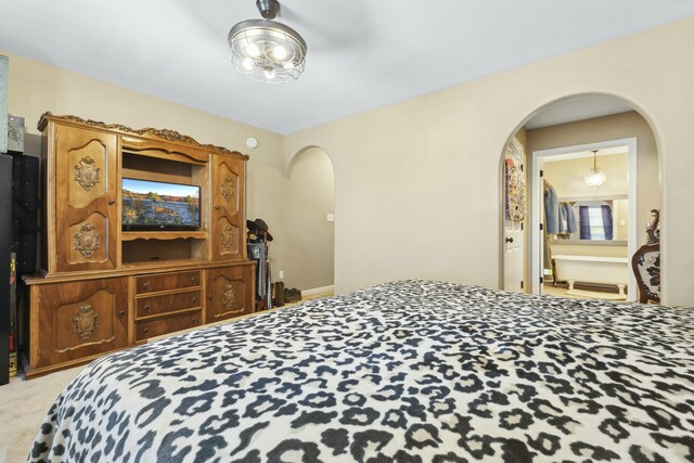 carpeted bedroom featuring connected bathroom