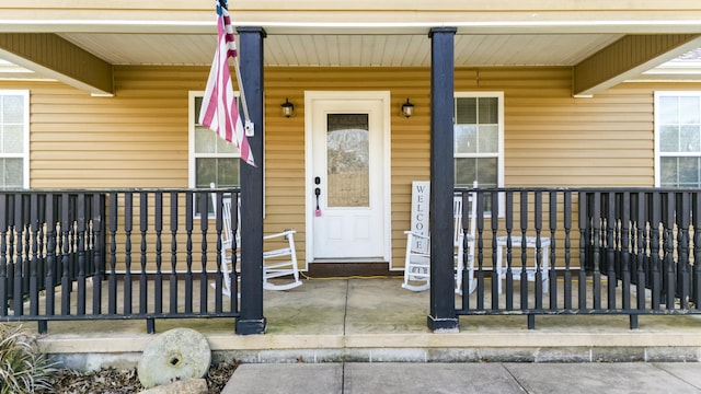 view of exterior entry featuring a porch