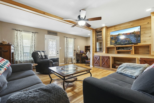 living room featuring light hardwood / wood-style flooring and ceiling fan