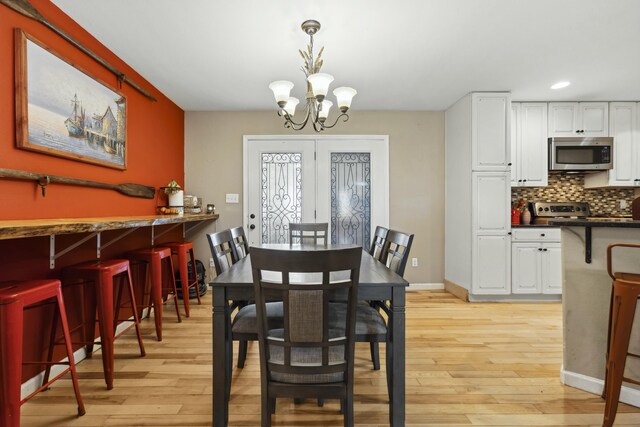 dining room with a chandelier and light hardwood / wood-style floors