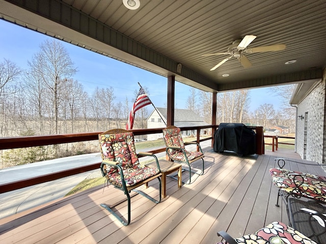 deck featuring ceiling fan and a grill