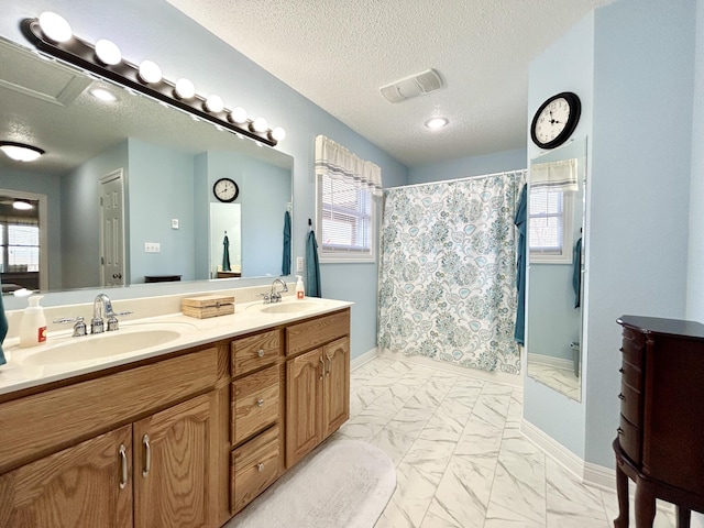 bathroom with vanity, a textured ceiling, and a shower with shower curtain