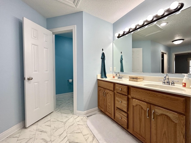 bathroom with vanity and a textured ceiling