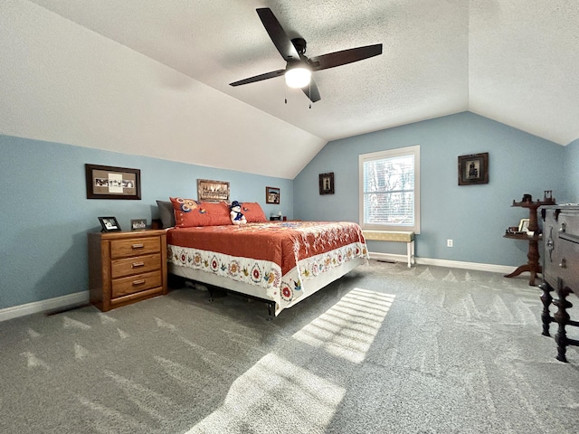 bedroom featuring vaulted ceiling, carpet floors, ceiling fan, and a textured ceiling