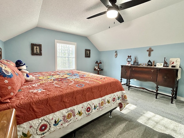 carpeted bedroom with ceiling fan, lofted ceiling, and a textured ceiling