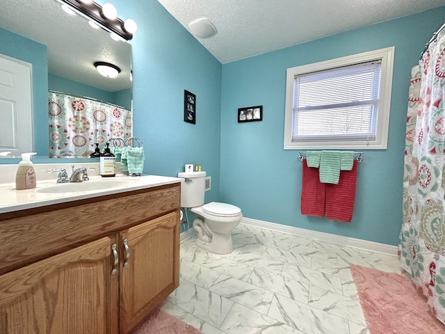 bathroom featuring vanity, toilet, and a textured ceiling