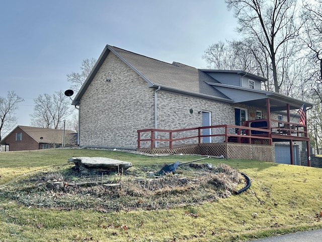 view of side of home with a yard and a garage