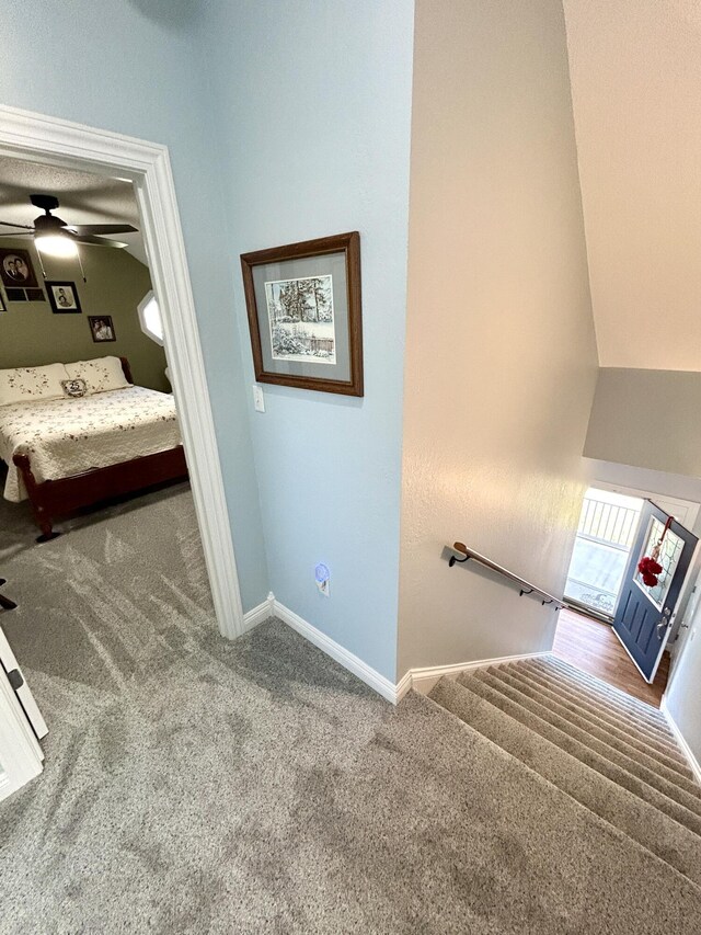 carpeted bedroom featuring ceiling fan, lofted ceiling, and a textured ceiling