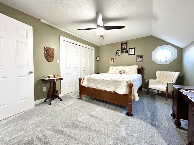 bedroom featuring vaulted ceiling, carpet, ceiling fan, a textured ceiling, and a closet