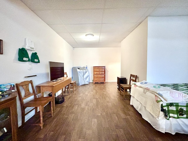 bedroom with hardwood / wood-style flooring and a paneled ceiling