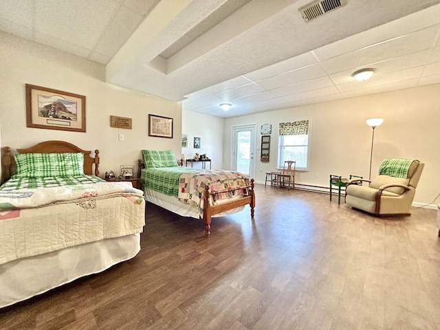 bedroom featuring hardwood / wood-style flooring, a baseboard radiator, access to outside, and a paneled ceiling