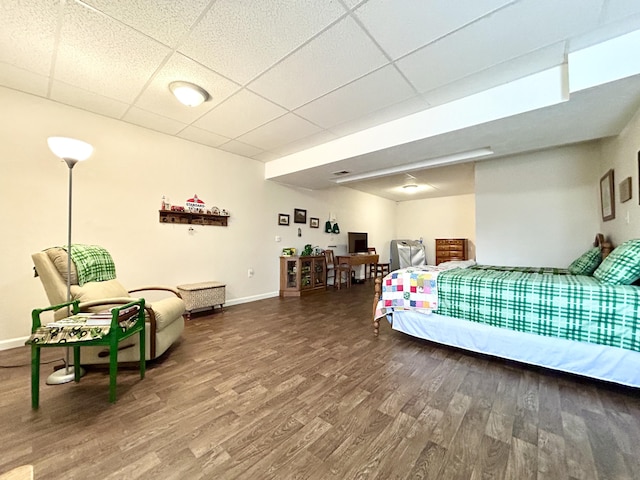 bedroom featuring hardwood / wood-style flooring and a paneled ceiling