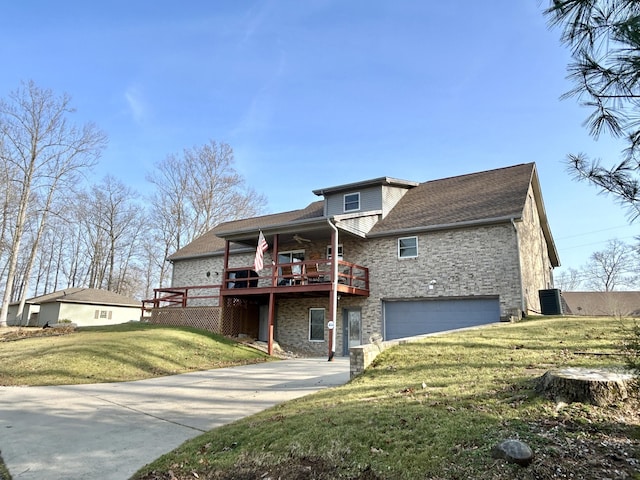 view of front of property featuring a garage, a wooden deck, central air condition unit, and a front lawn