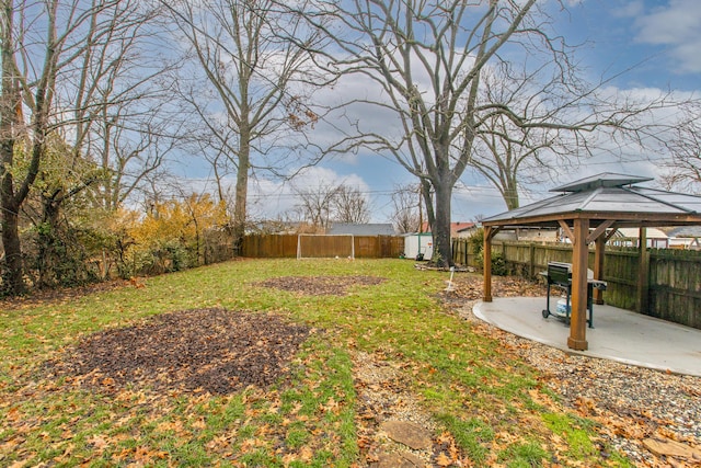 view of yard with a storage shed, a gazebo, and a patio