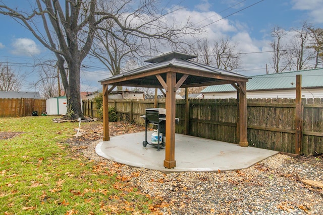 view of yard with a gazebo, a patio, and a shed