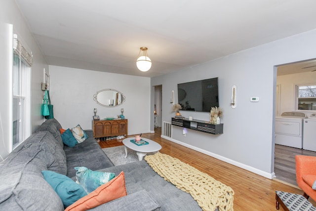 living room featuring separate washer and dryer and hardwood / wood-style flooring