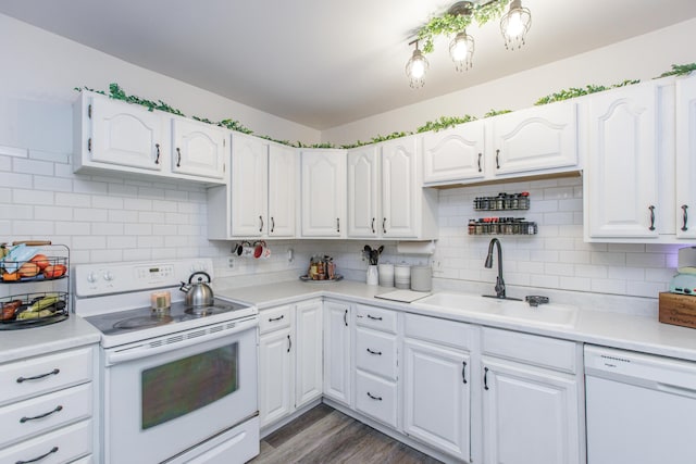 kitchen featuring sink, white appliances, white cabinetry, tasteful backsplash, and dark hardwood / wood-style flooring