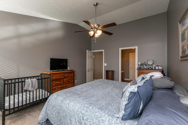 carpeted bedroom with ceiling fan, high vaulted ceiling, and a textured ceiling