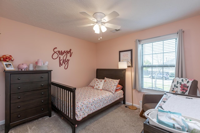 bedroom with ceiling fan and light colored carpet