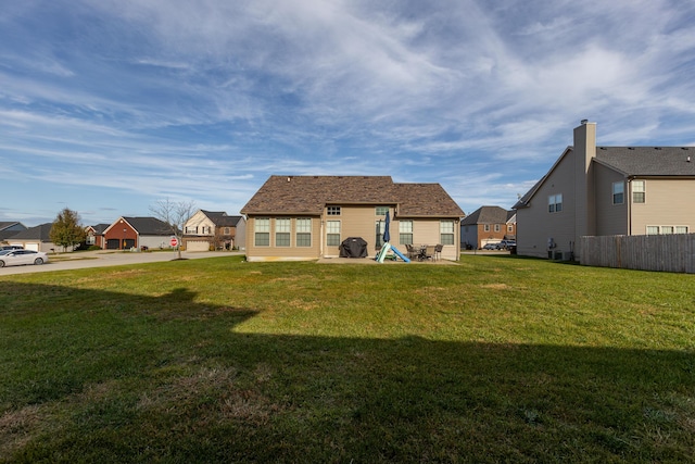 back of property featuring a yard and a patio area