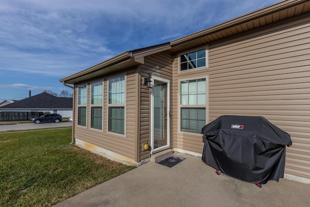 view of exterior entry with a lawn