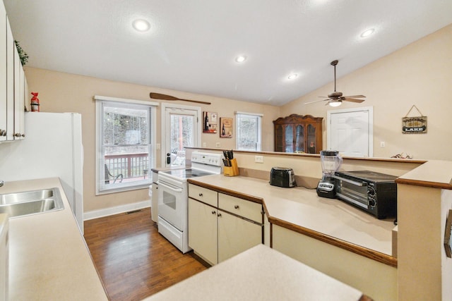 kitchen featuring sink, white appliances, a wealth of natural light, and vaulted ceiling