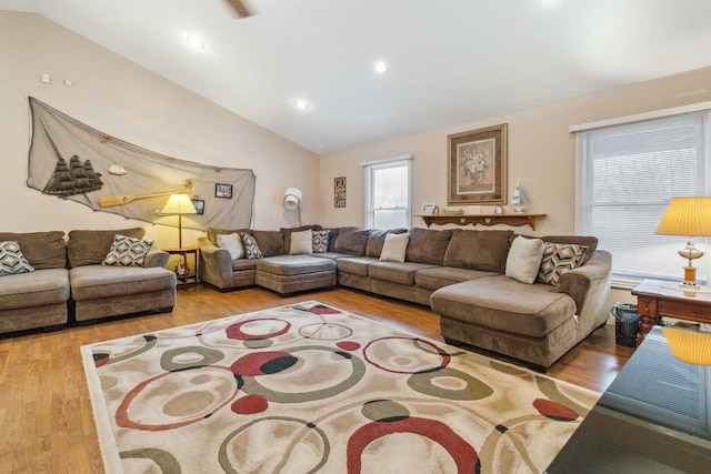 living room featuring lofted ceiling and light wood-type flooring